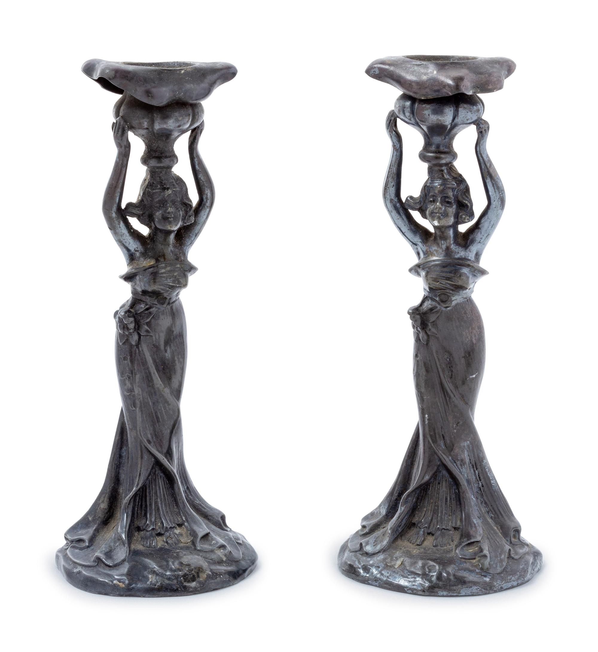 A Pair of Art Nouveau Cast Metal Figural Candlesticks