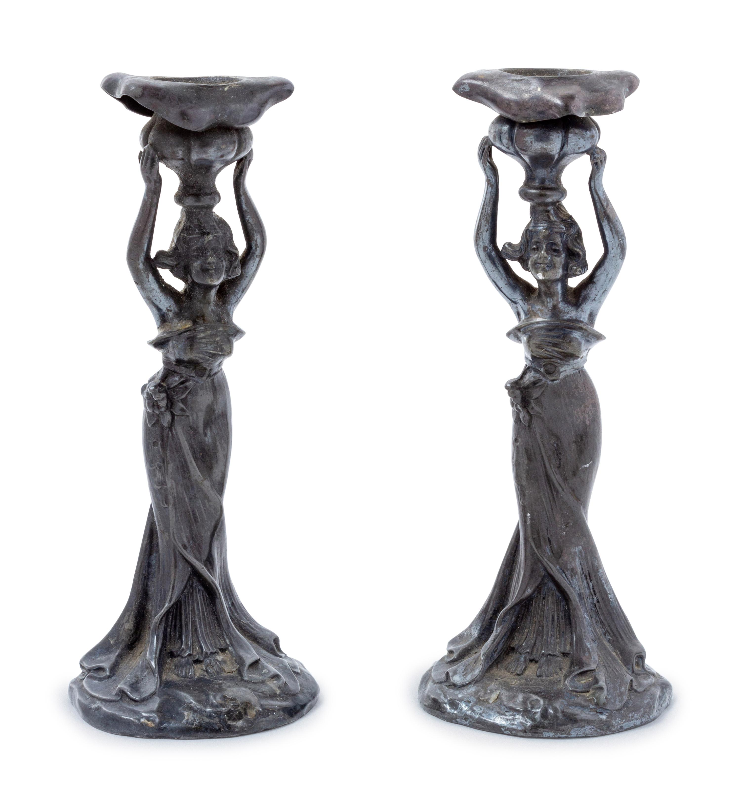 A Pair of Art Nouveau Cast Metal Figural Candlesticks