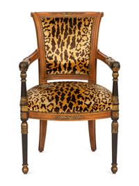 A Directoire Style Ebonized and Parcel Gilt Walnut Fauteuil