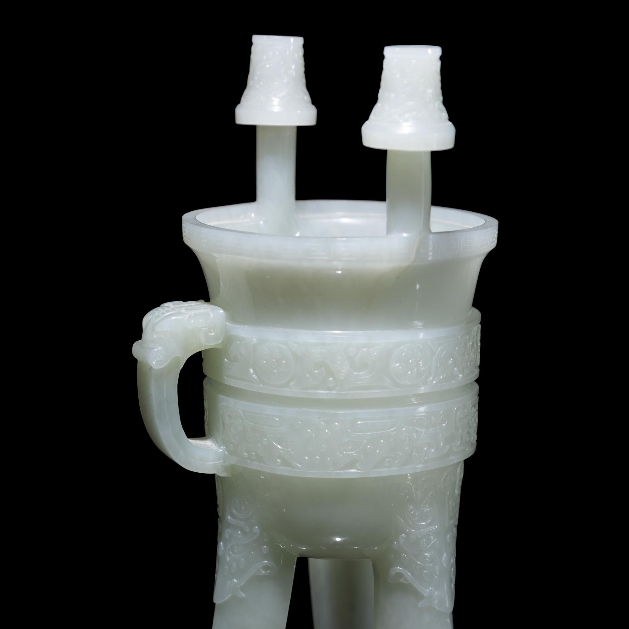 A Chinese Carved Pale Celadon Jade Tripod Vessel, Jia, Late Qing - Early Republic Period 晚清/民國 青白玉仿古斝