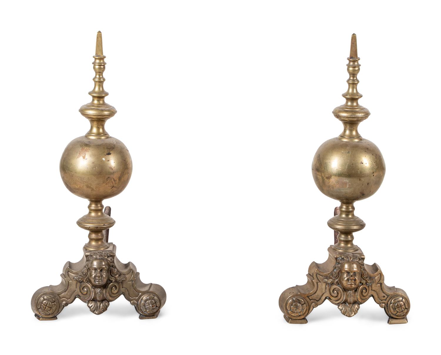 A Pair of Continental Brass Andirons with Masks