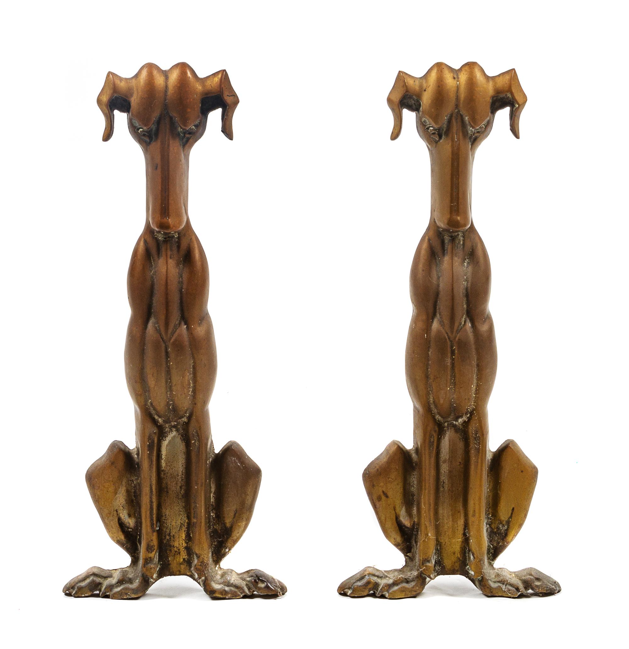 A Pair of Bronze Andirons depicting Stylized Dogs Height 18 inches.