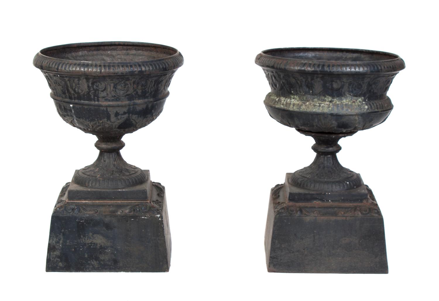 A Pair of Cast Iron Garden Urns Height 21 inches.