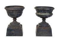 A Pair of Cast Iron Garden Urns Height 21 inches.