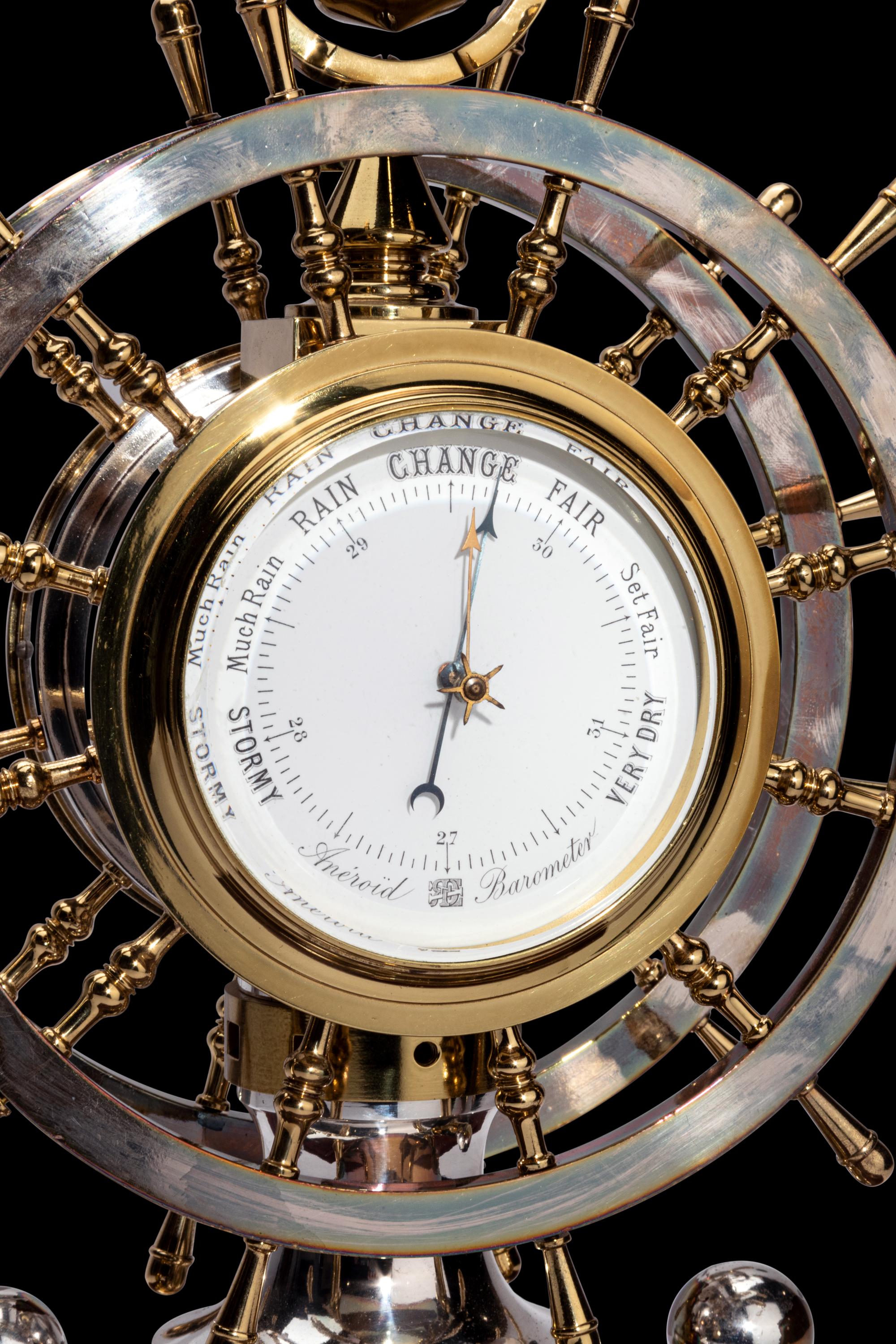 An English Steel and Brass Ship's Wheel Clock and Barometer, E&E Emanuel