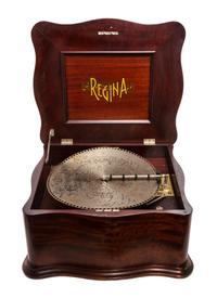 A Regina Mahogany Cased Table Top Disc Music Box, Height 13 x width 23 x depth 20 1/2 inches.