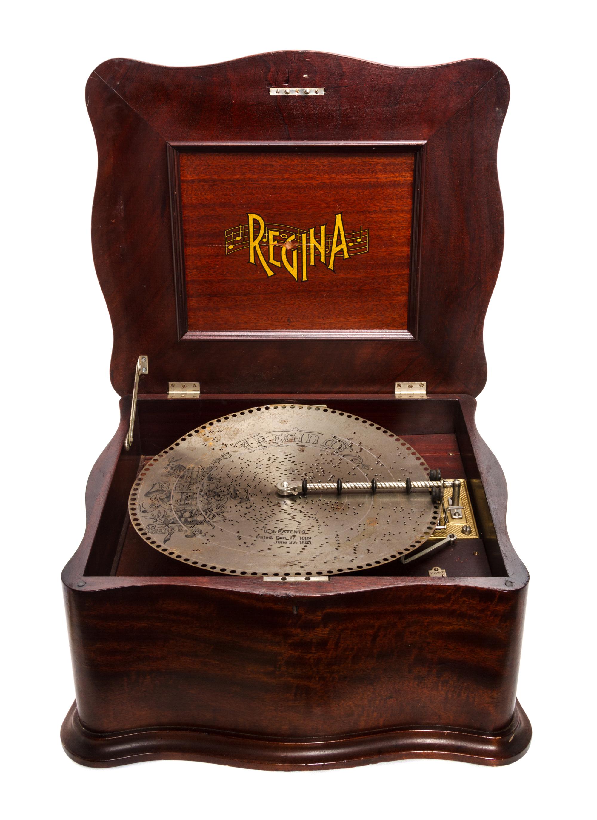 A Regina Mahogany Cased Table Top Disc Music Box, Height 13 x width 23 x depth 20 1/2 inches.