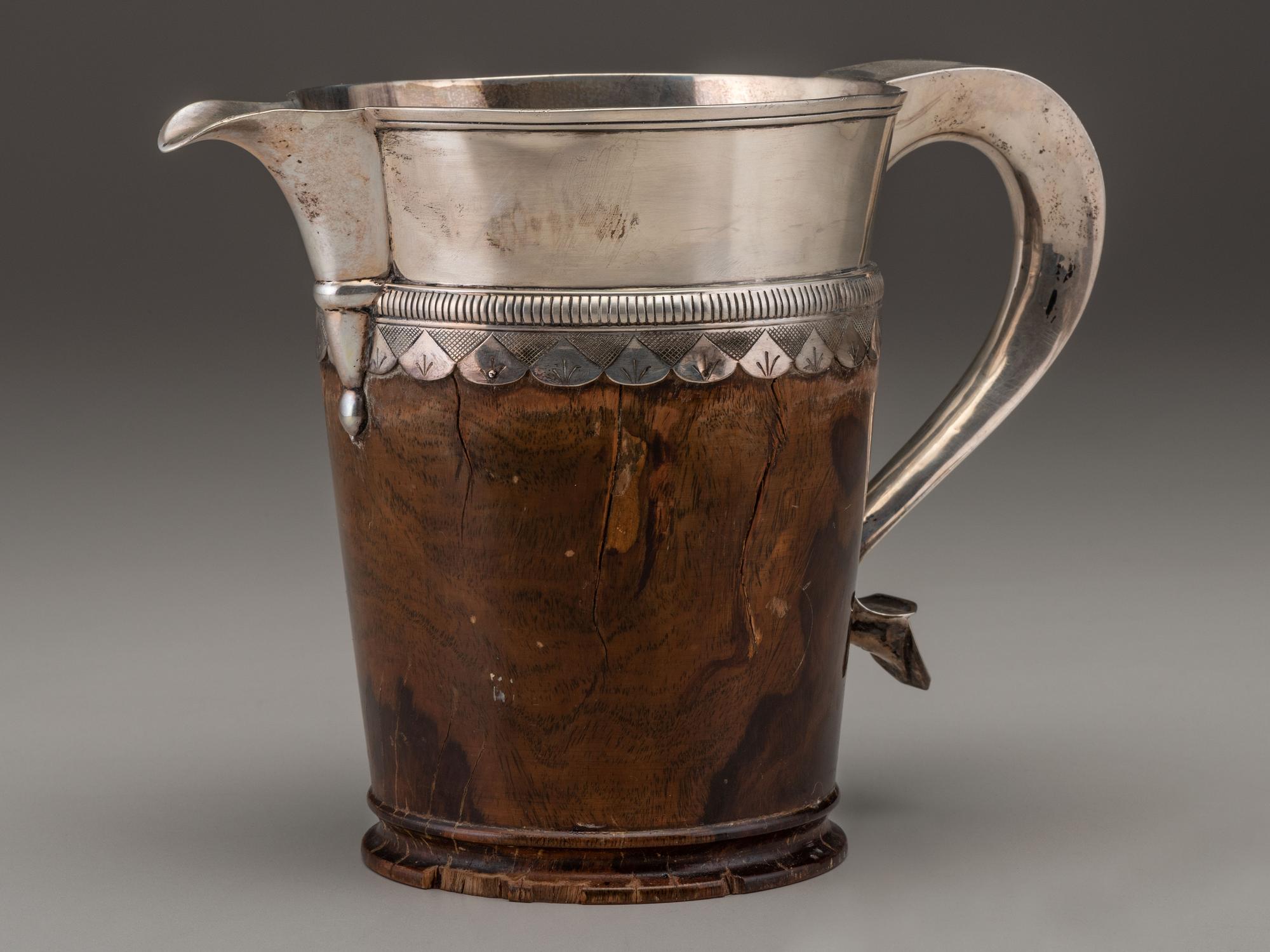 A Silver Mounted Mahogany Pitcher and Six Cups