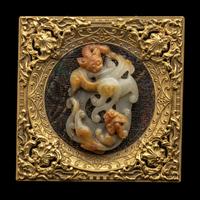 A Chinese Russet and Pale Celadon Jade 'Double Dragons' Pendant