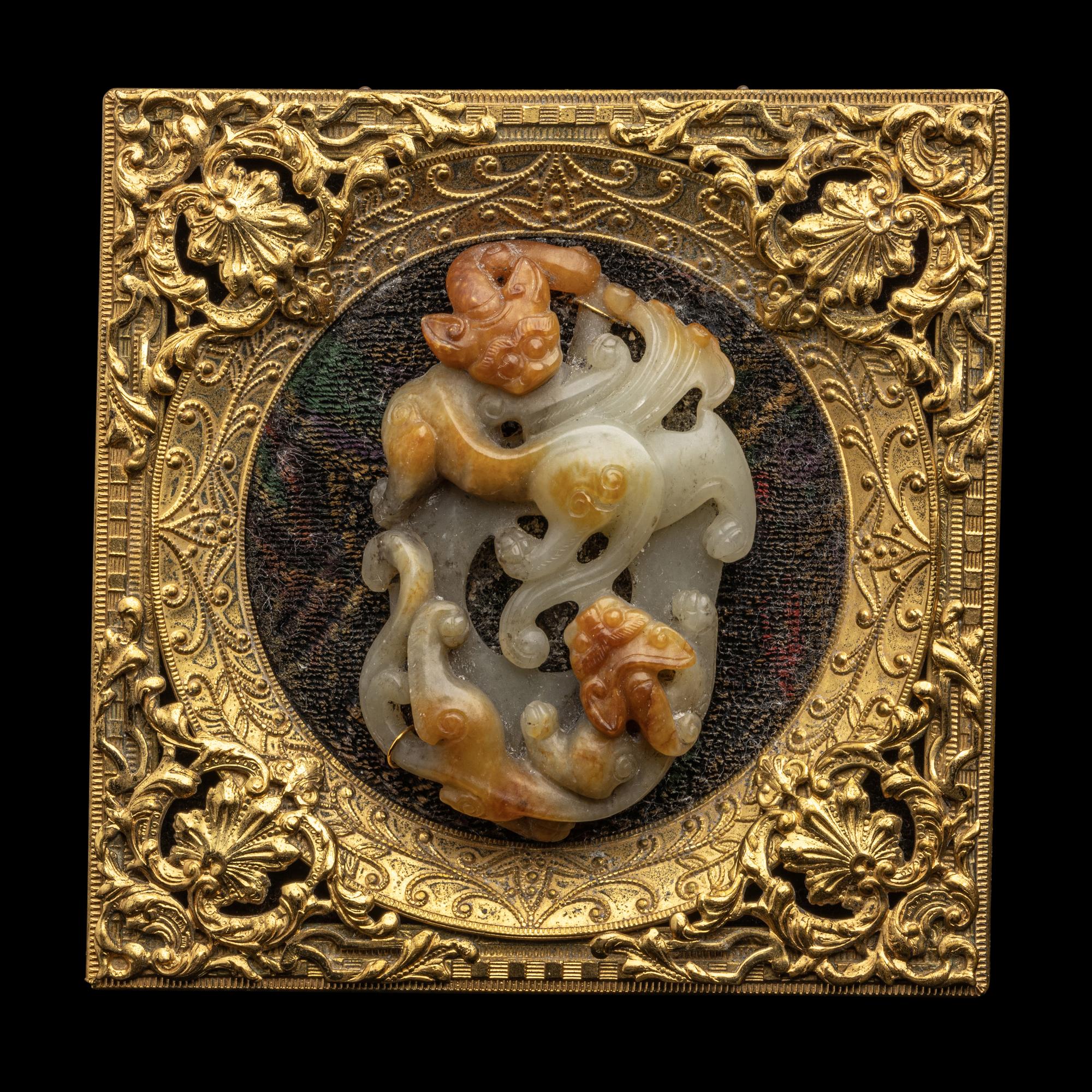 A Chinese Russet and Pale Celadon Jade 'Double Dragons' Pendant