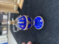 A 14 Karat Vari-Color Gold, Guilloché Enamel, Diamond, and Cabochon Jewel-Mounted Egg-Form Perfume and a Related Guilloché Enamel, 14 Karat Vari-Color Gold, Diamond, and Cabochon-Mounted Surprise Egg
