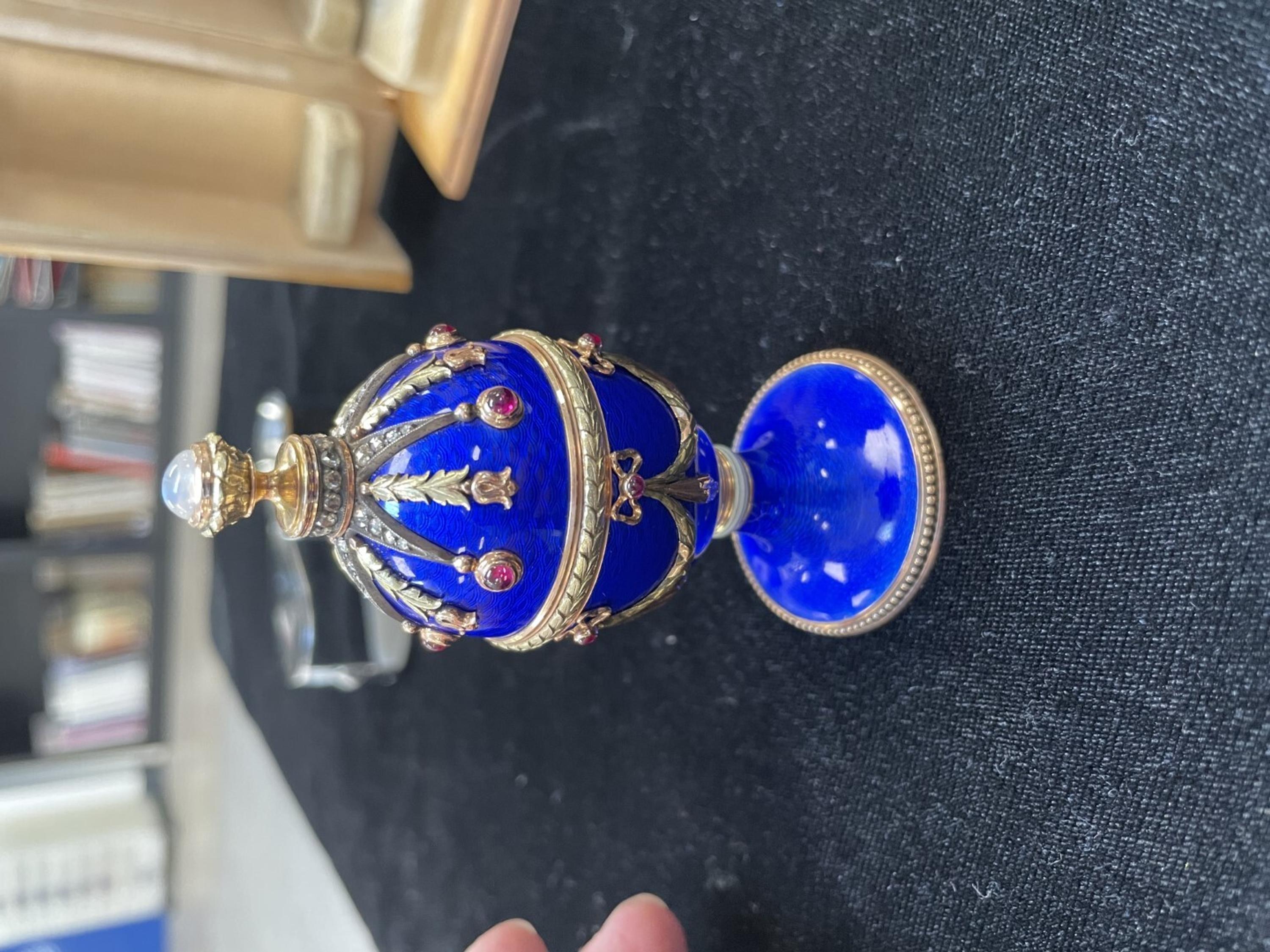 A 14 Karat Vari-Color Gold, Guilloché Enamel, Diamond, and Cabochon Jewel-Mounted Egg-Form Perfume and a Related Guilloché Enamel, 14 Karat Vari-Color Gold, Diamond, and Cabochon-Mounted Surprise Egg