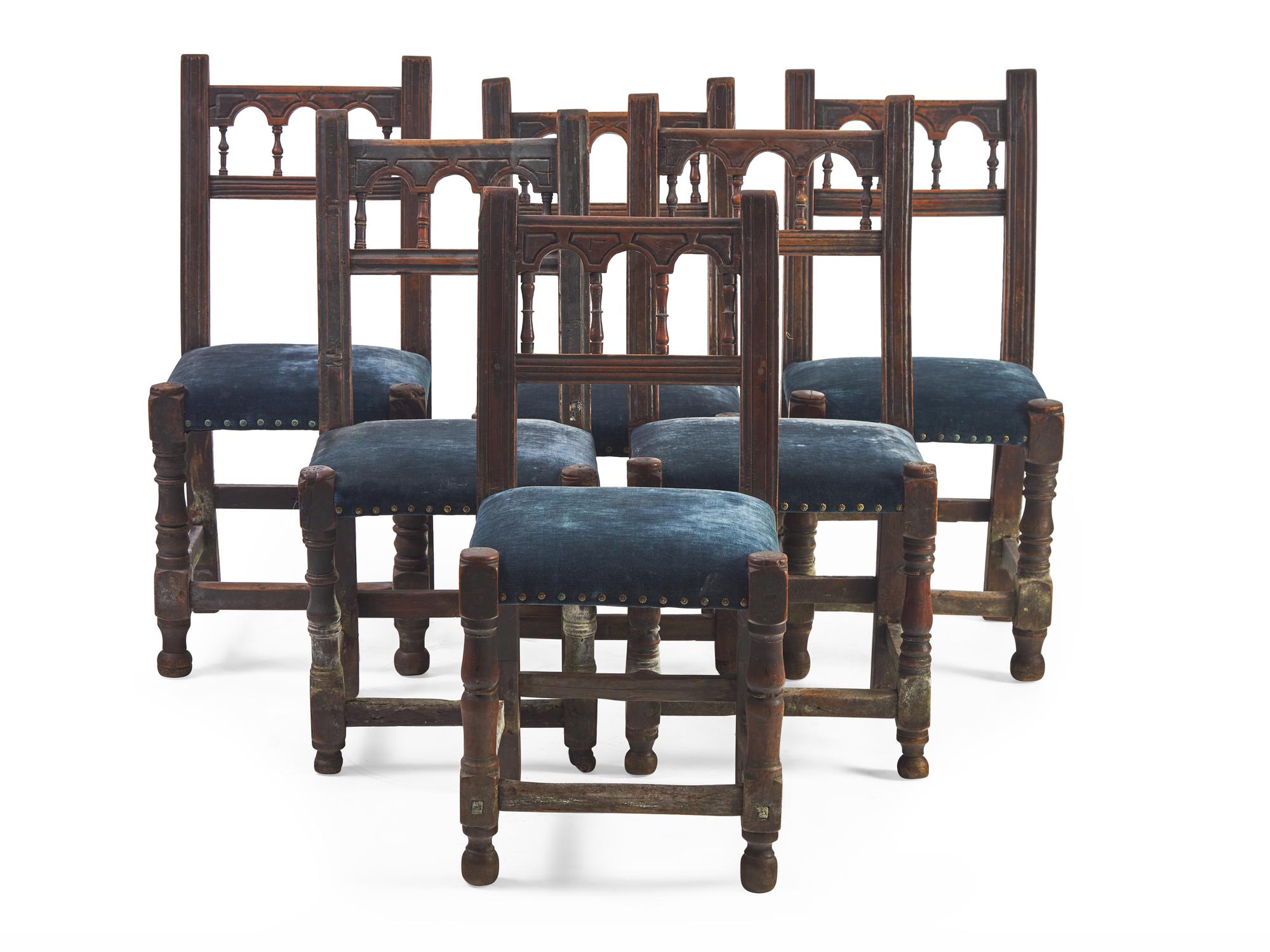 A set of Six Spanish Baroque Carved Walnut and Upholstered Side Chairs
