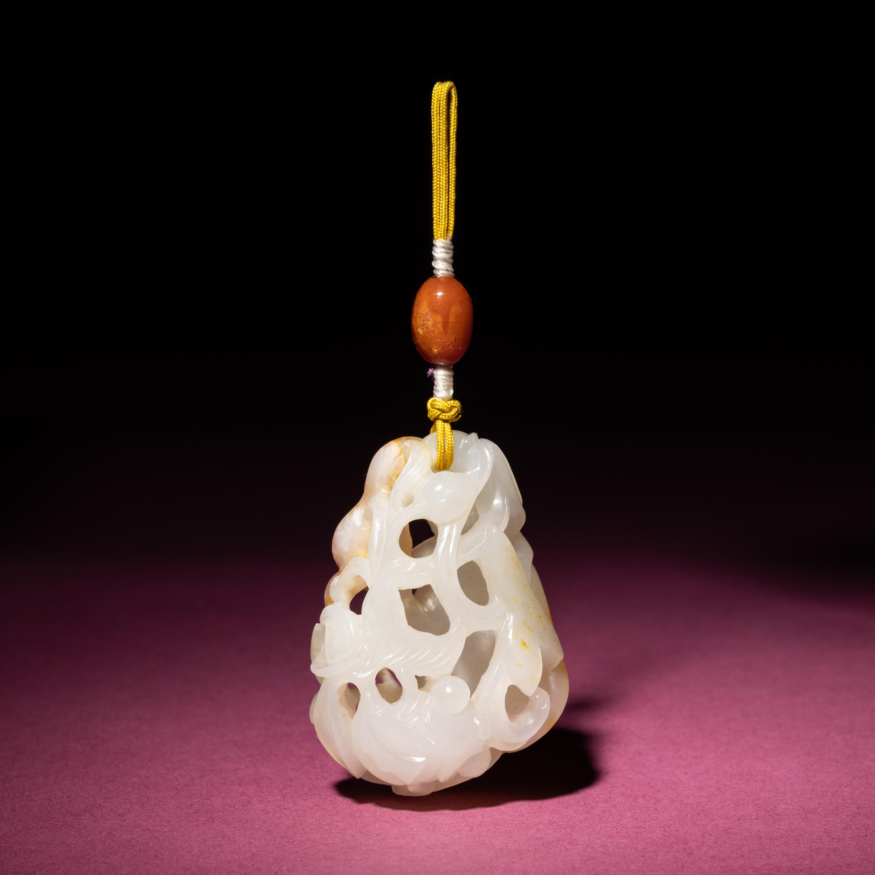 A Chinese Russet and White Jade Reticulated 'Lotus' Pendant, 18th/19th Century — 清中期 白玉帶皮鏤雕蓮紋佩