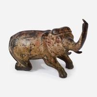 An Indian Polychromed Metal Kneeling Elephant