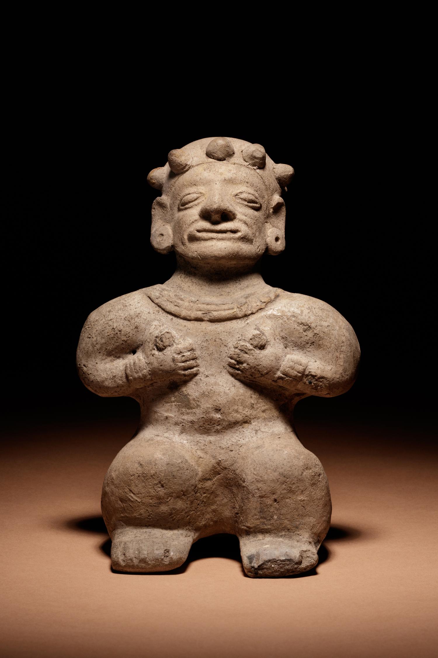 A Tumaco Female Figure Holding Breasts