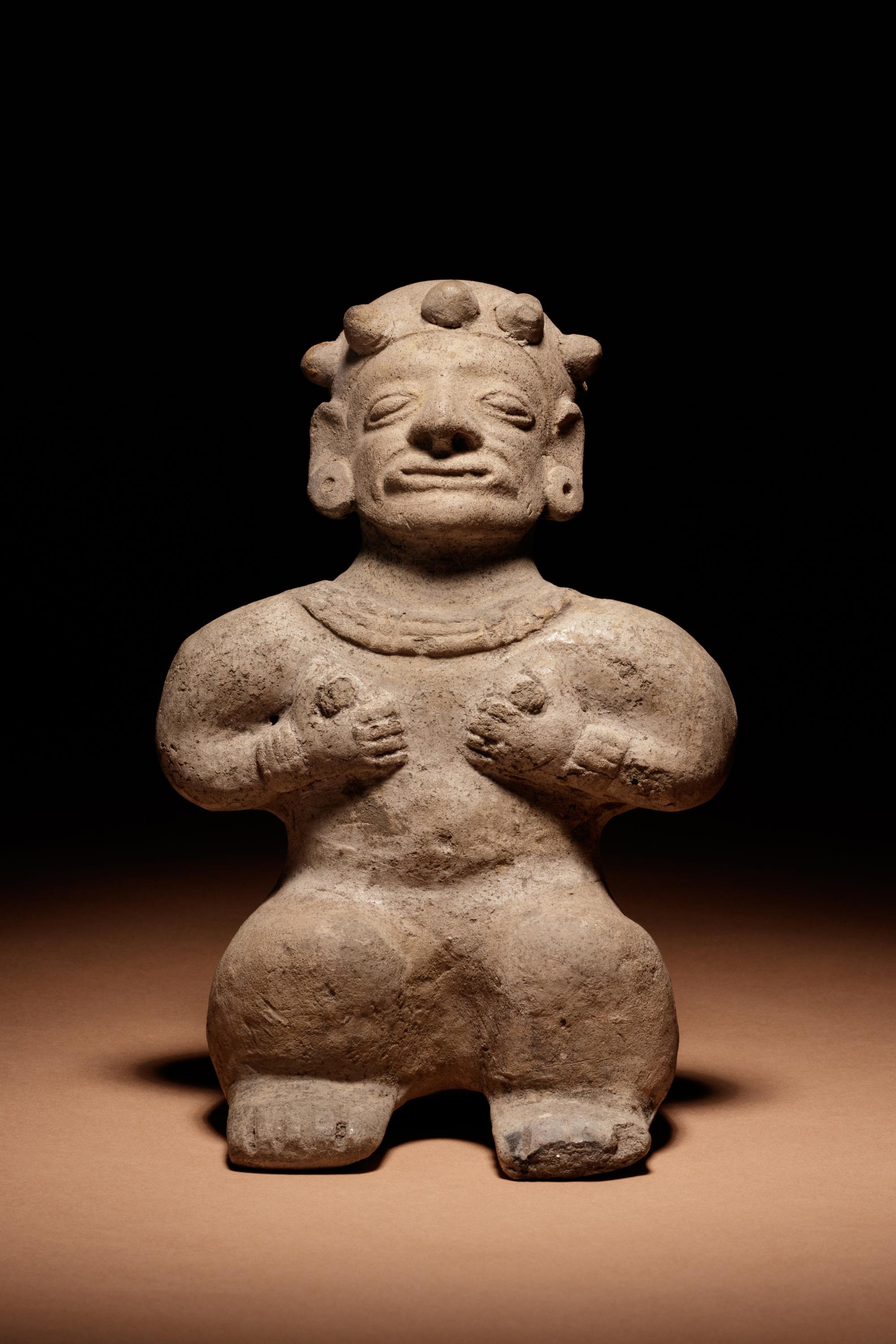 A Tumaco Female Figure Holding Breasts