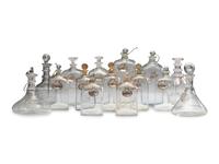 Fifteen Glass Decanters with English Shell-Form Silver Bottle Tags