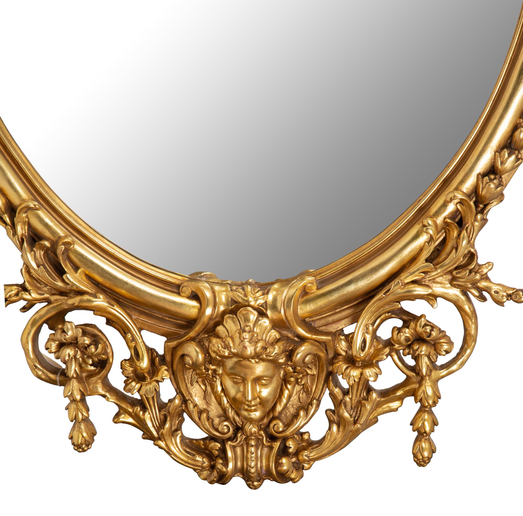 A Pair of Italian Baroque Carved Giltwood Oval Mirrors — 19TH CENTURY