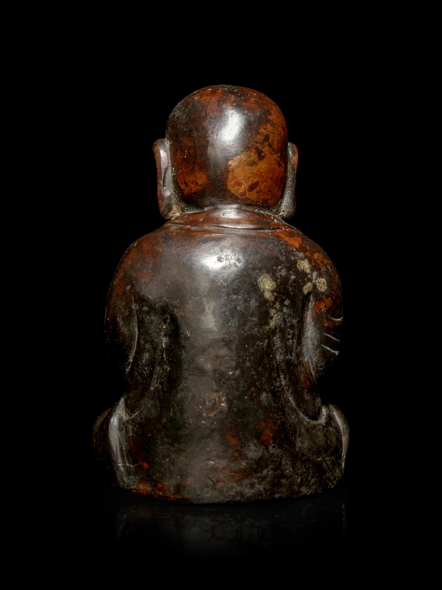 A Small Bronze Figure of a Seated Monk