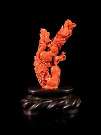 A Red Coral Carving of Squirrels and Grapes