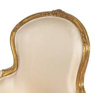 A Pair of Louis XV Carved Giltwood Bergères