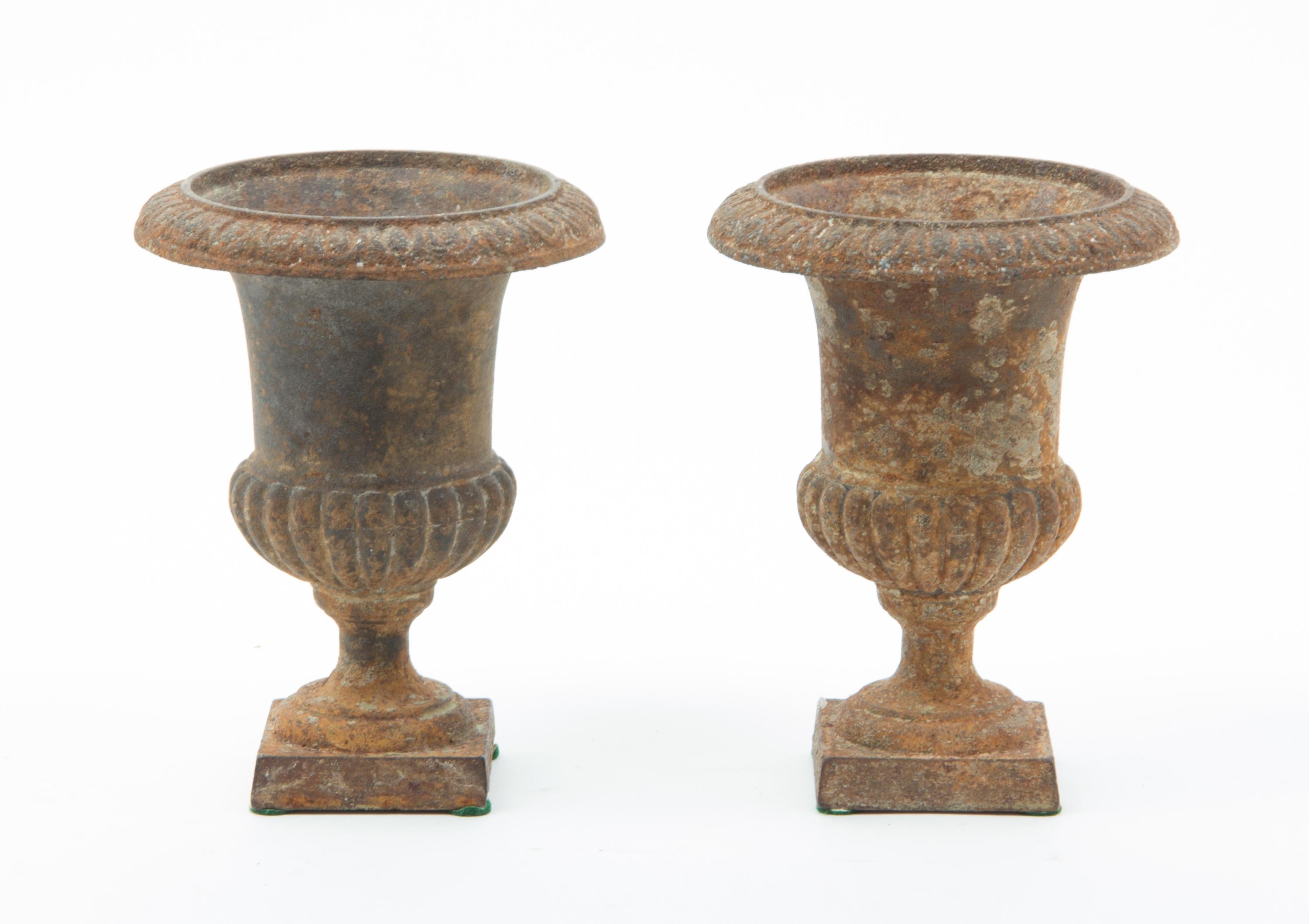 A Pair of Victorian Cast Iron Urns Height 6 1/4 inches.