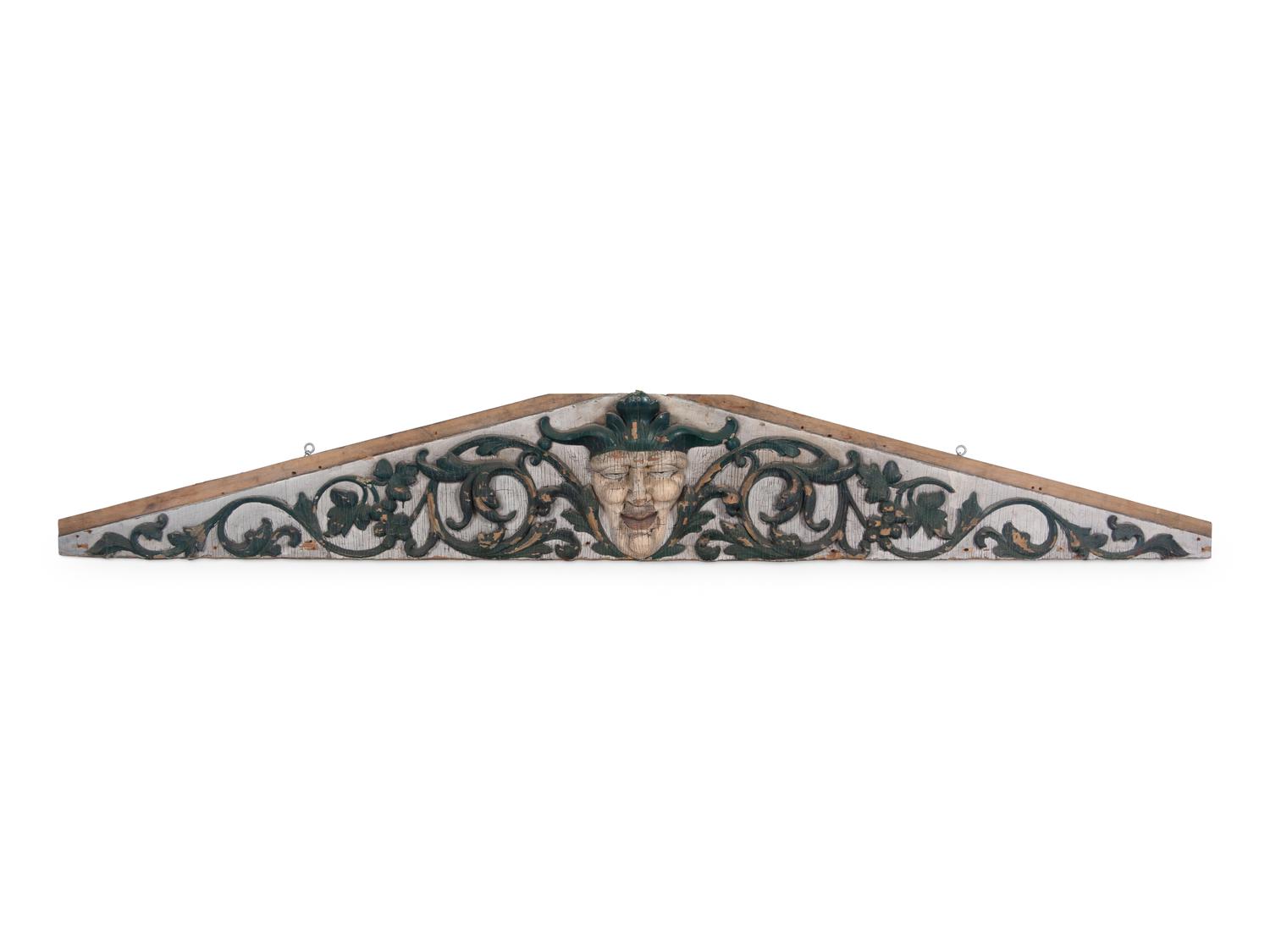 A Carved and Painted Pine Pediment Panel