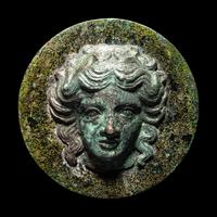 A Greek Bronze Mirror with the Head of a Woman