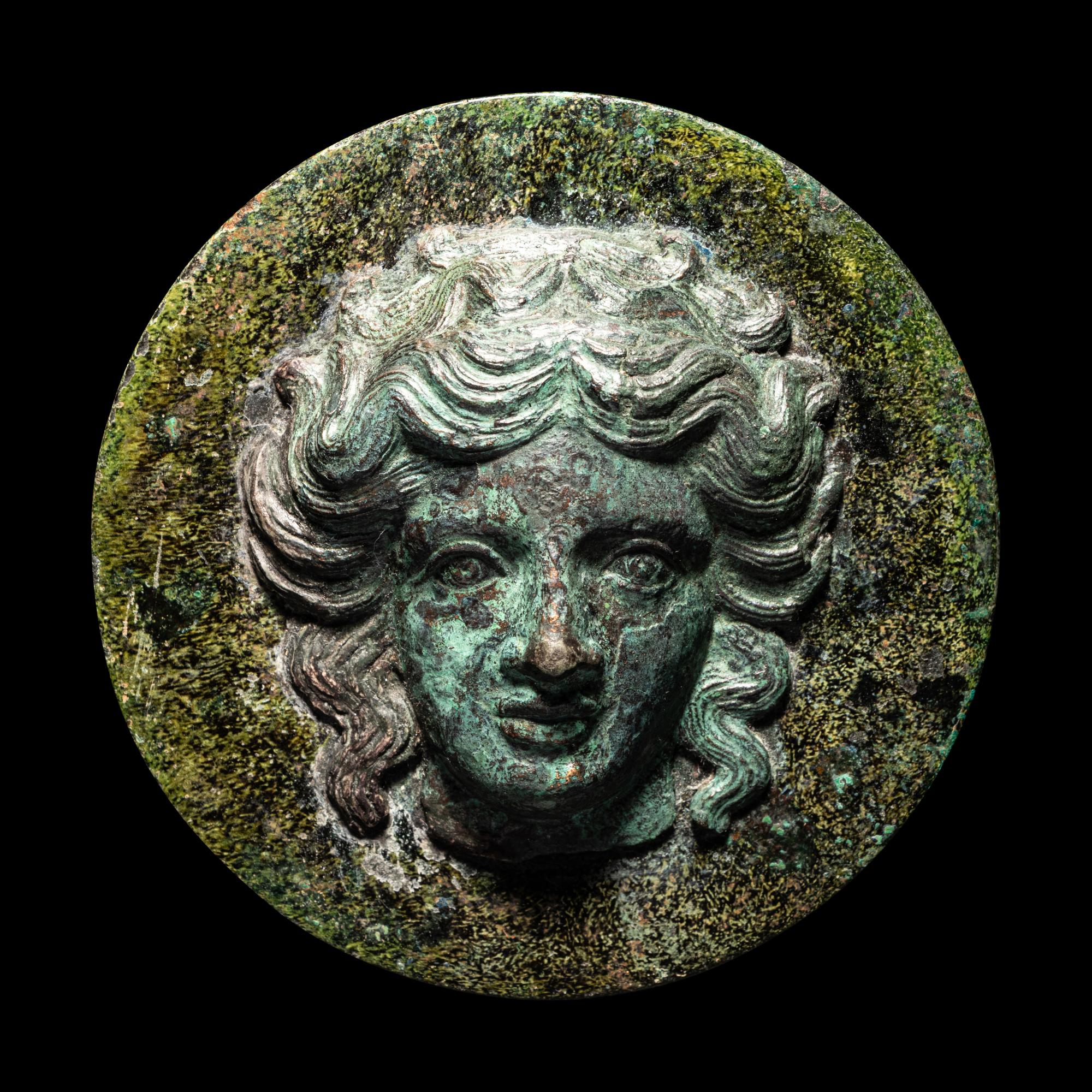 A Greek Bronze Mirror with the Head of a Woman