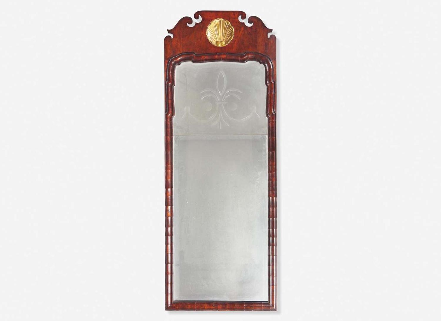 A Queen Anne fret-carved burl walnut and parcel-gilt looking glass, circa 1730-1750