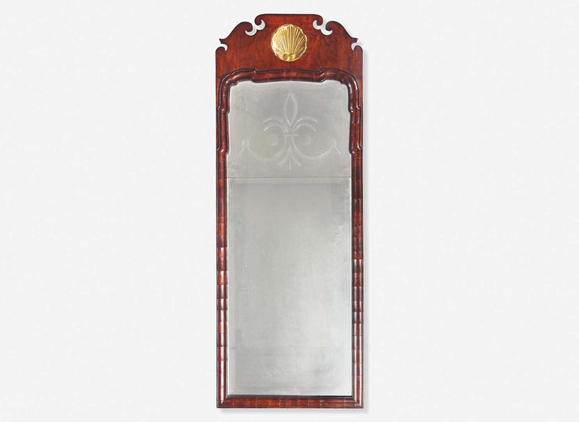 A Queen Anne fret-carved burl walnut and parcel-gilt looking glass, circa 1730-1750