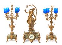 A Late Victorian Gilt Metal and Onyx Clock Garniture, after Auguste Moreau, Height of clock 23 1/4 inches.