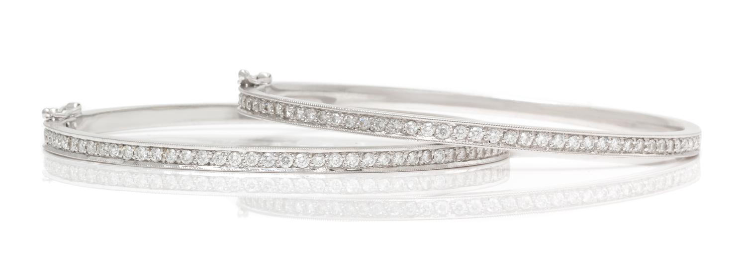 A Pair of 18 Karat White Gold and Diamond Bangle Bracelets, 16.90 dwts.