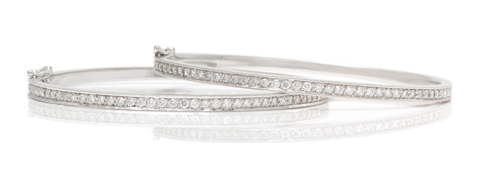 A Pair of 18 Karat White Gold and Diamond Bangle Bracelets, 16.90 dwts.