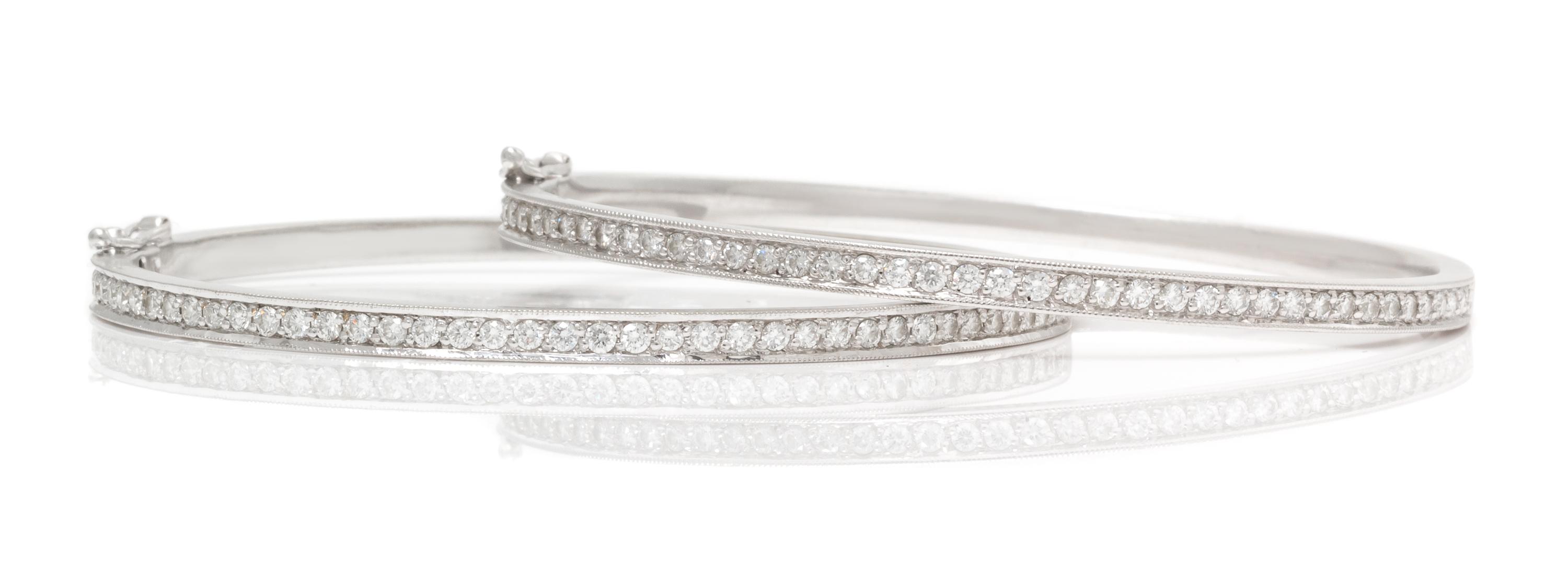A Pair of 18 Karat White Gold and Diamond Bangle Bracelets, 16.90 dwts.