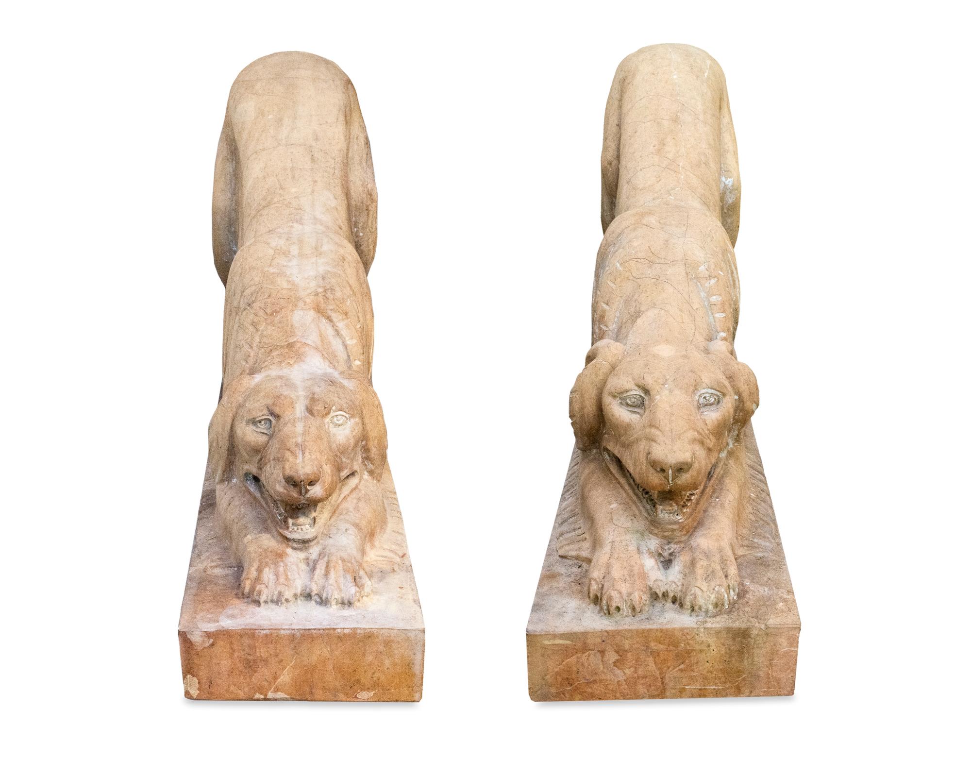 A Pair of Carved Marble Crouching Dogs — 20TH CENTURY