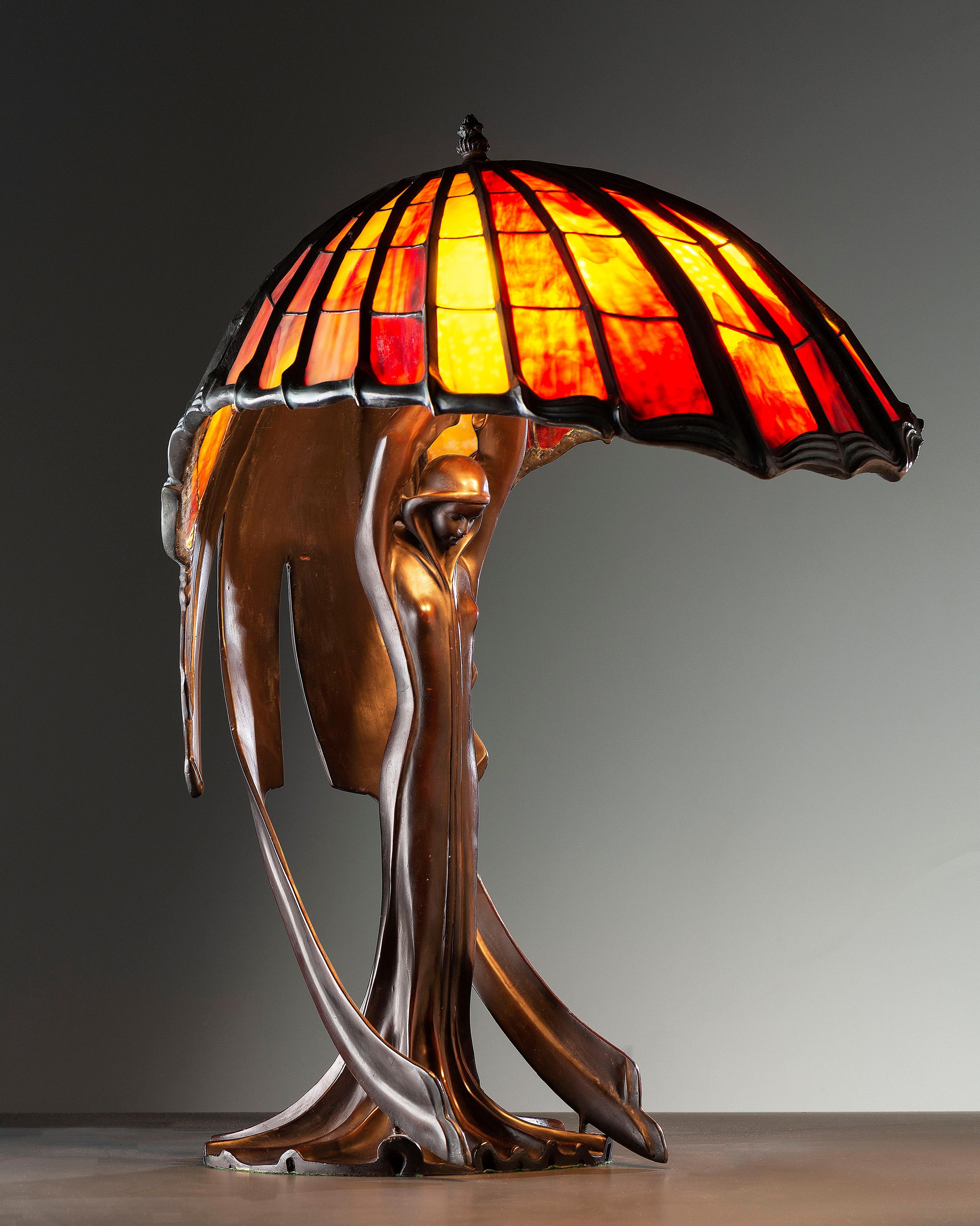 A Cast Bronze and Glass Figural Table Lamp
