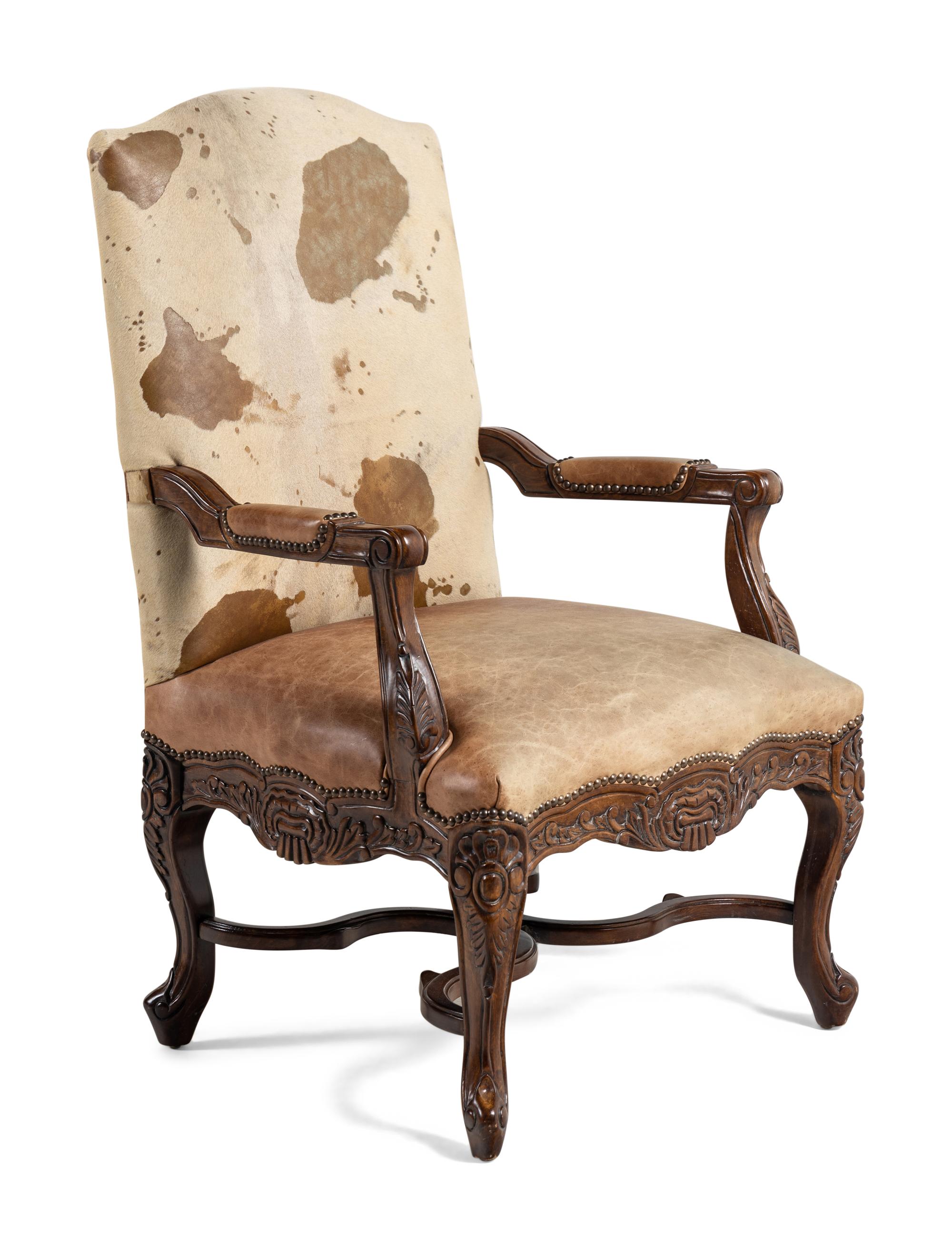 A Pair of Louis XV Style Carved Walnut Fauteuils