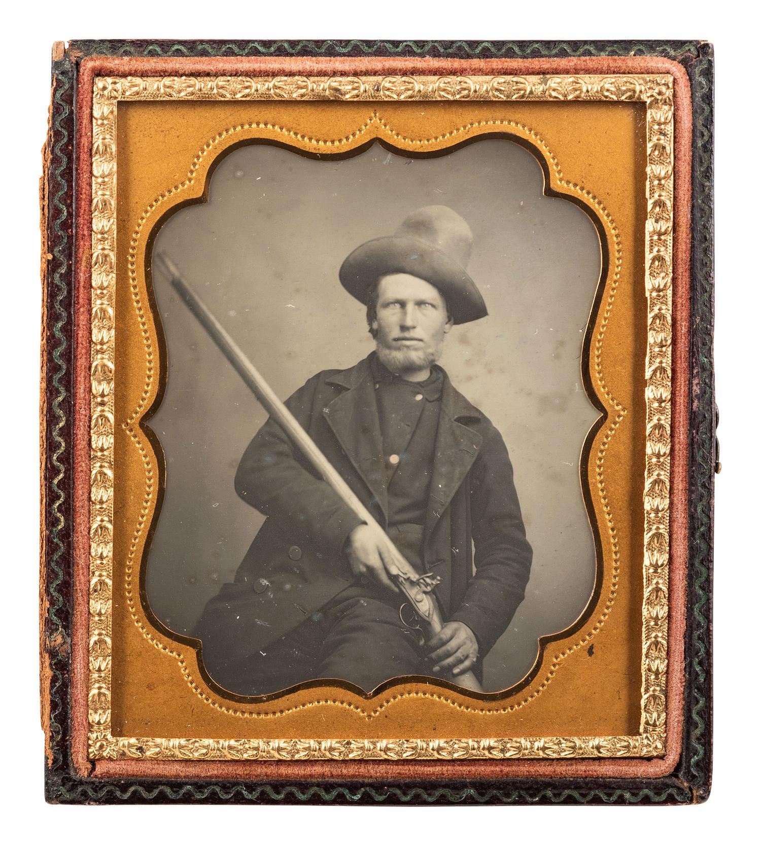 [EARLY PHOTOGRAPHY]. Sixth plate daguerreotype of a tough outdoorsman holding a large flintlock fowler.