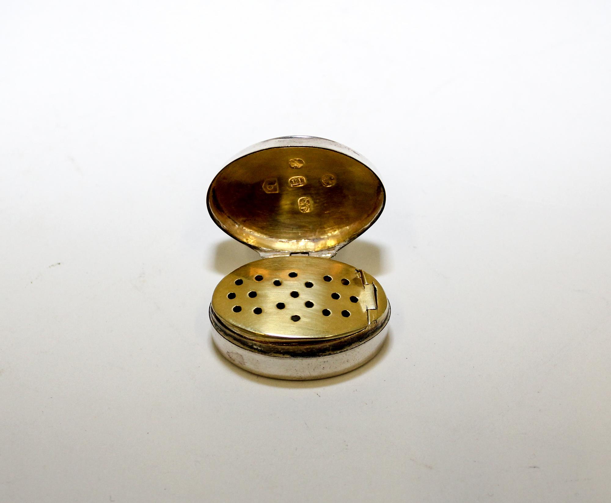A George III Silver Vinaigrette, John Turner, Birmingham, 1799, the case of oval form with a gilt decorated interior.