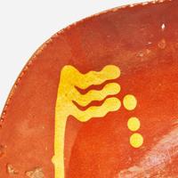 A glazed and slip-decorated redware loaf dish Pennsylvania, 19th century