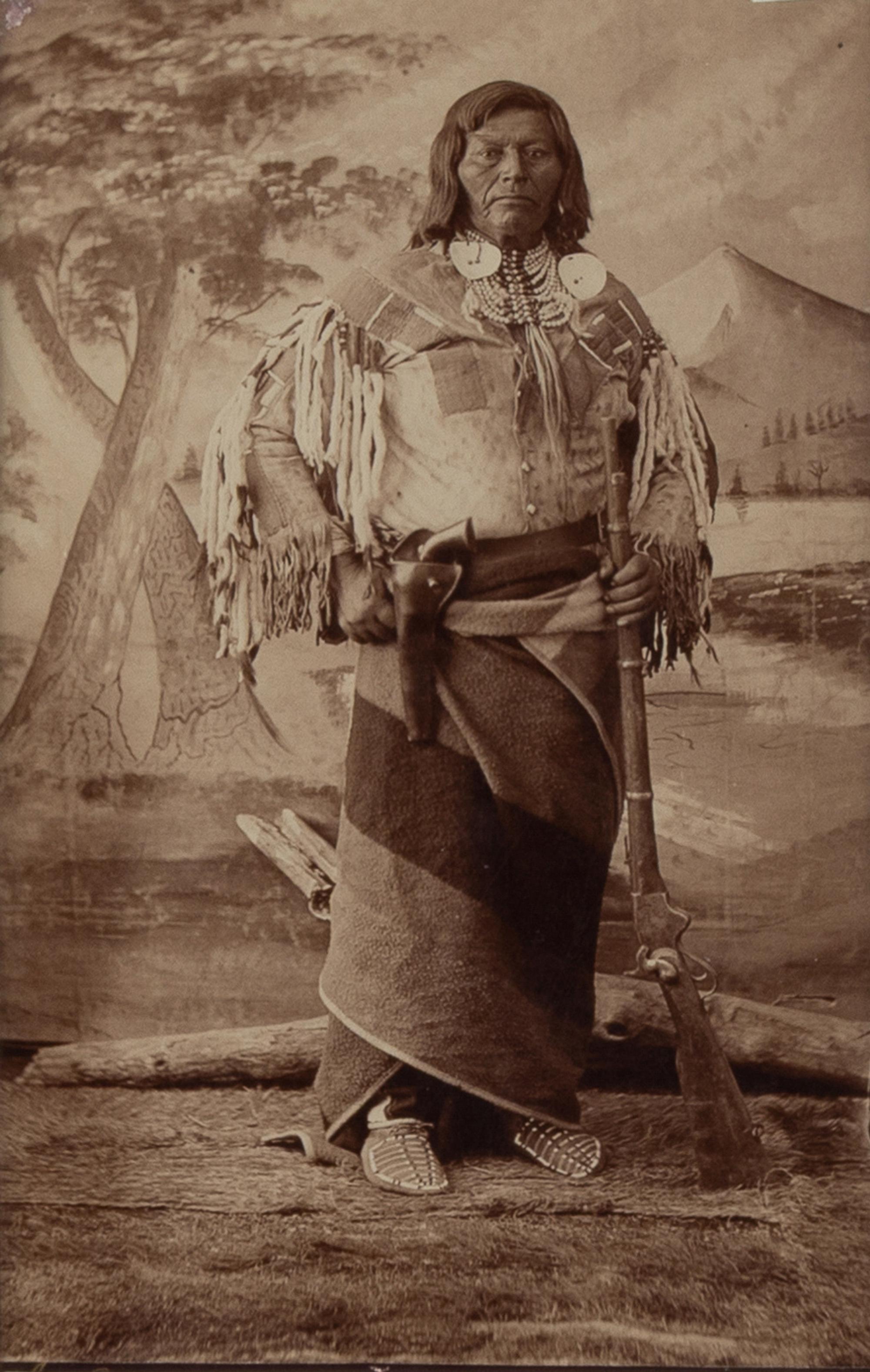 H.B. Calfee (American, 1847-1912) — Studio Portrait of a Double-Armed Native American Leader