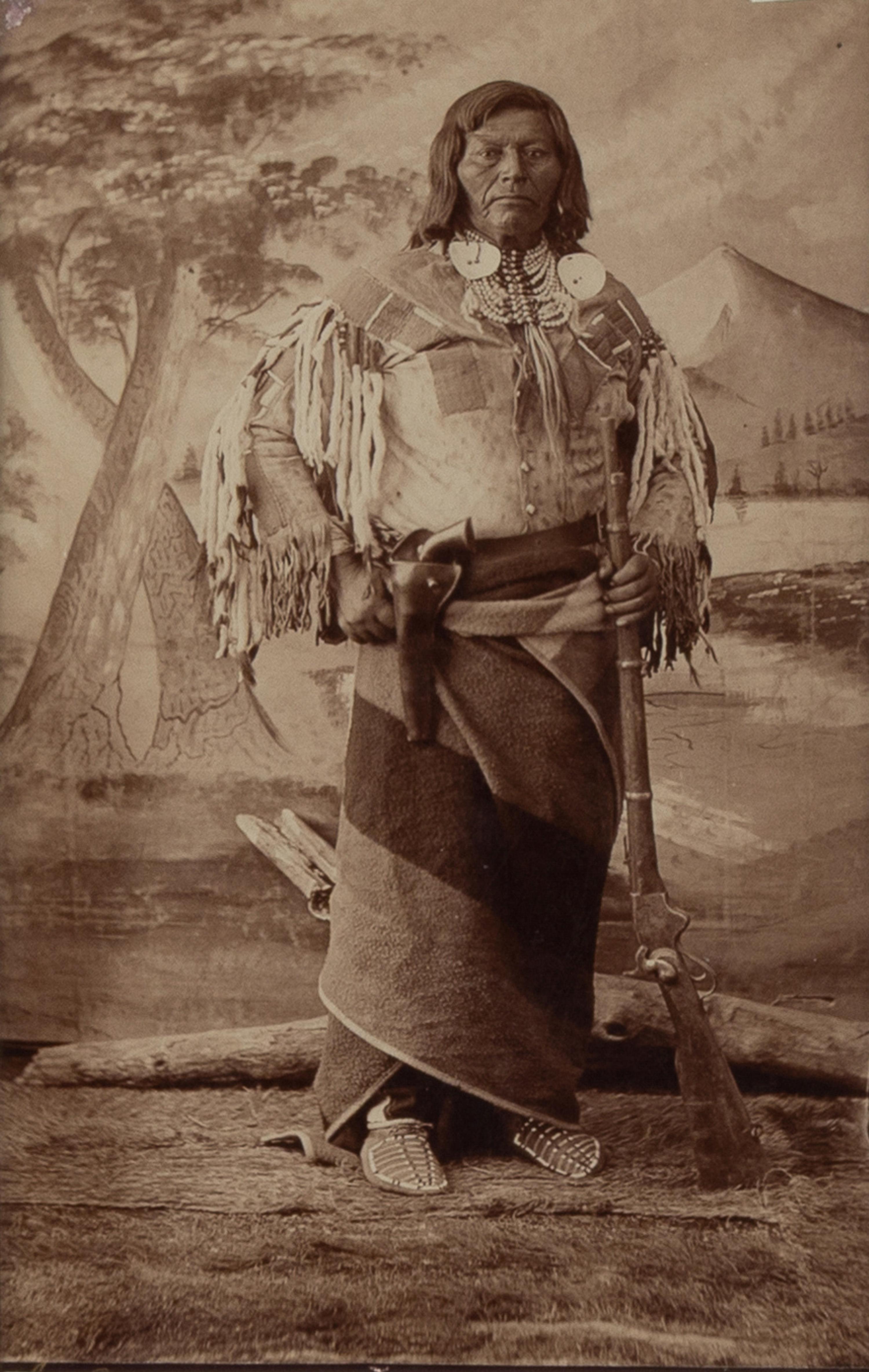 H.B. Calfee (American, 1847-1912) — Studio Portrait of a Double-Armed Native American Leader