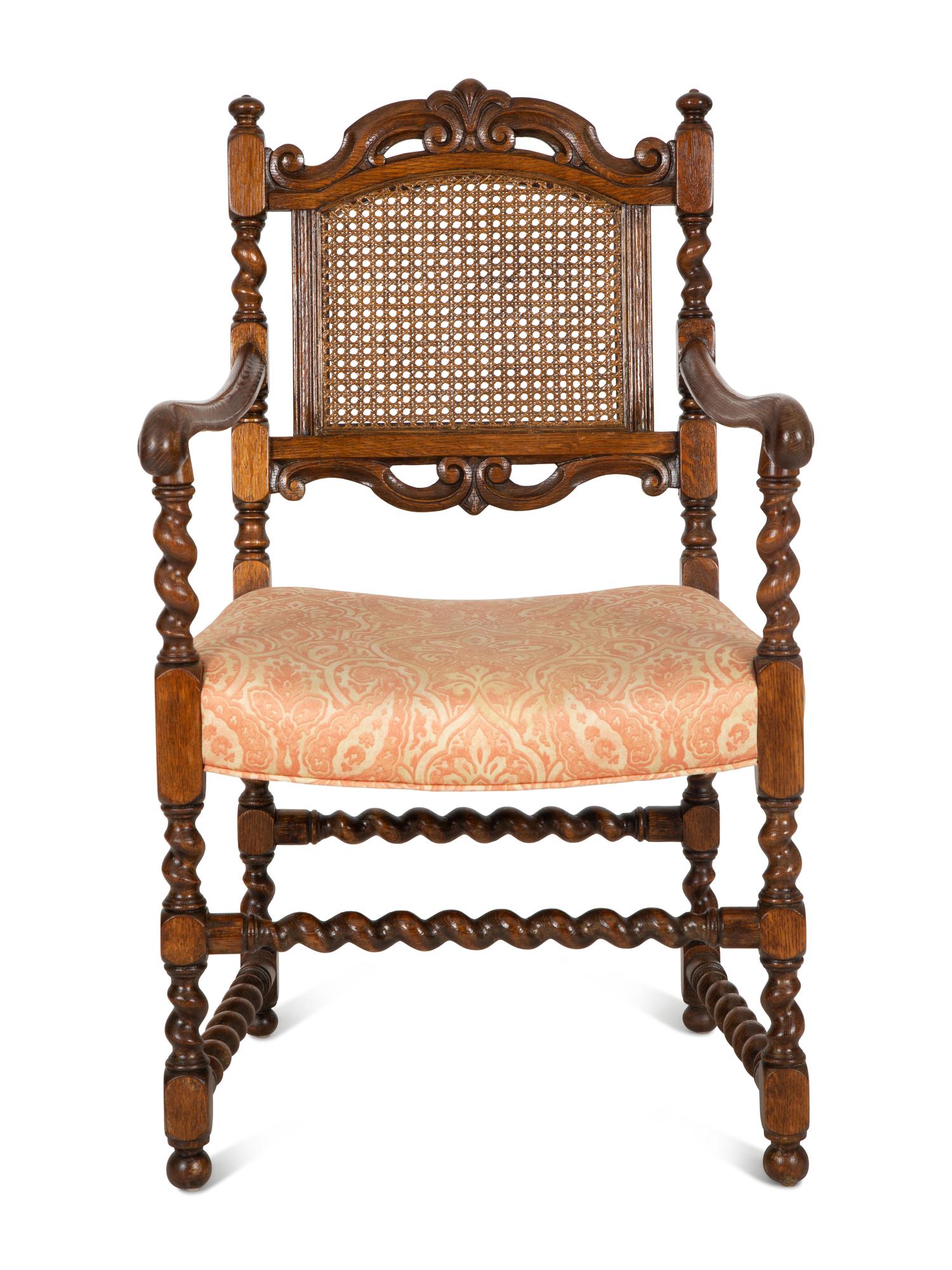 A William and Mary Style Carved Oak Cane Back Armchair
