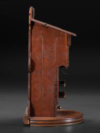 A Carved Wood Change Machine