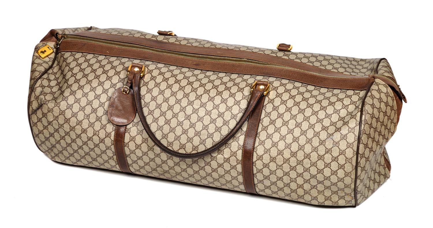 A Gucci Monogram Canvas Duffle Bag, 11" H x 31" W x 15" D; Handle drop: 8.5".