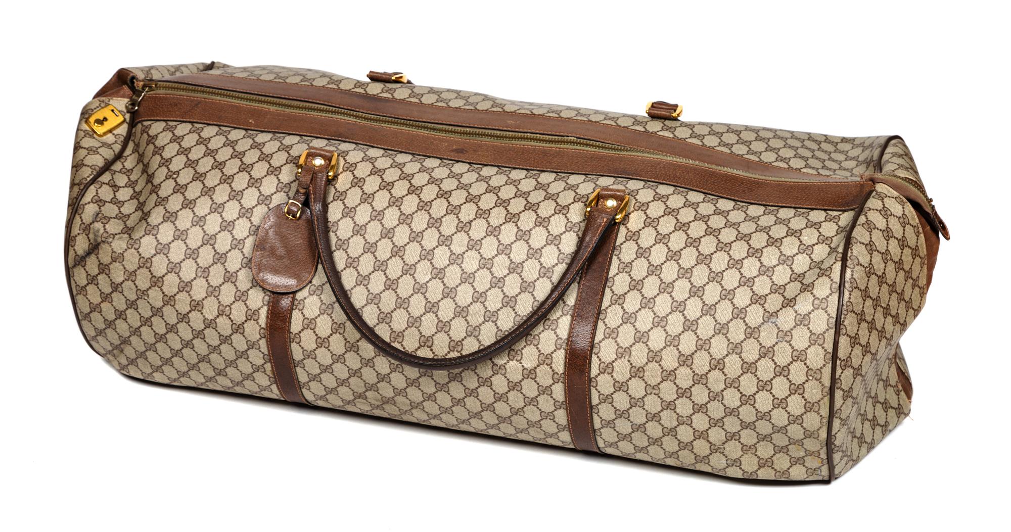 A Gucci Monogram Canvas Duffle Bag, 11" H x 31" W x 15" D; Handle drop: 8.5".