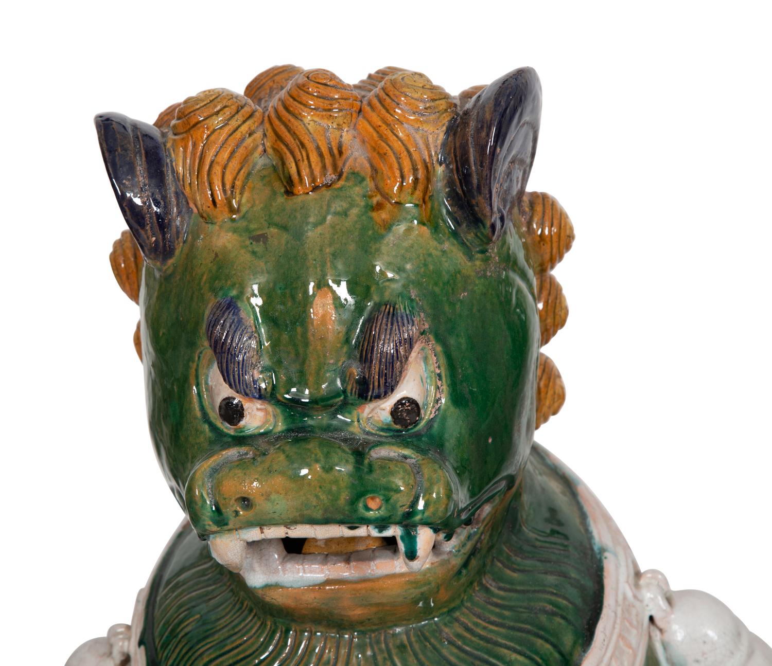 A Pair of Chinese Sançai Glazed Ceramic Guardian Lions on Pedestal Bases