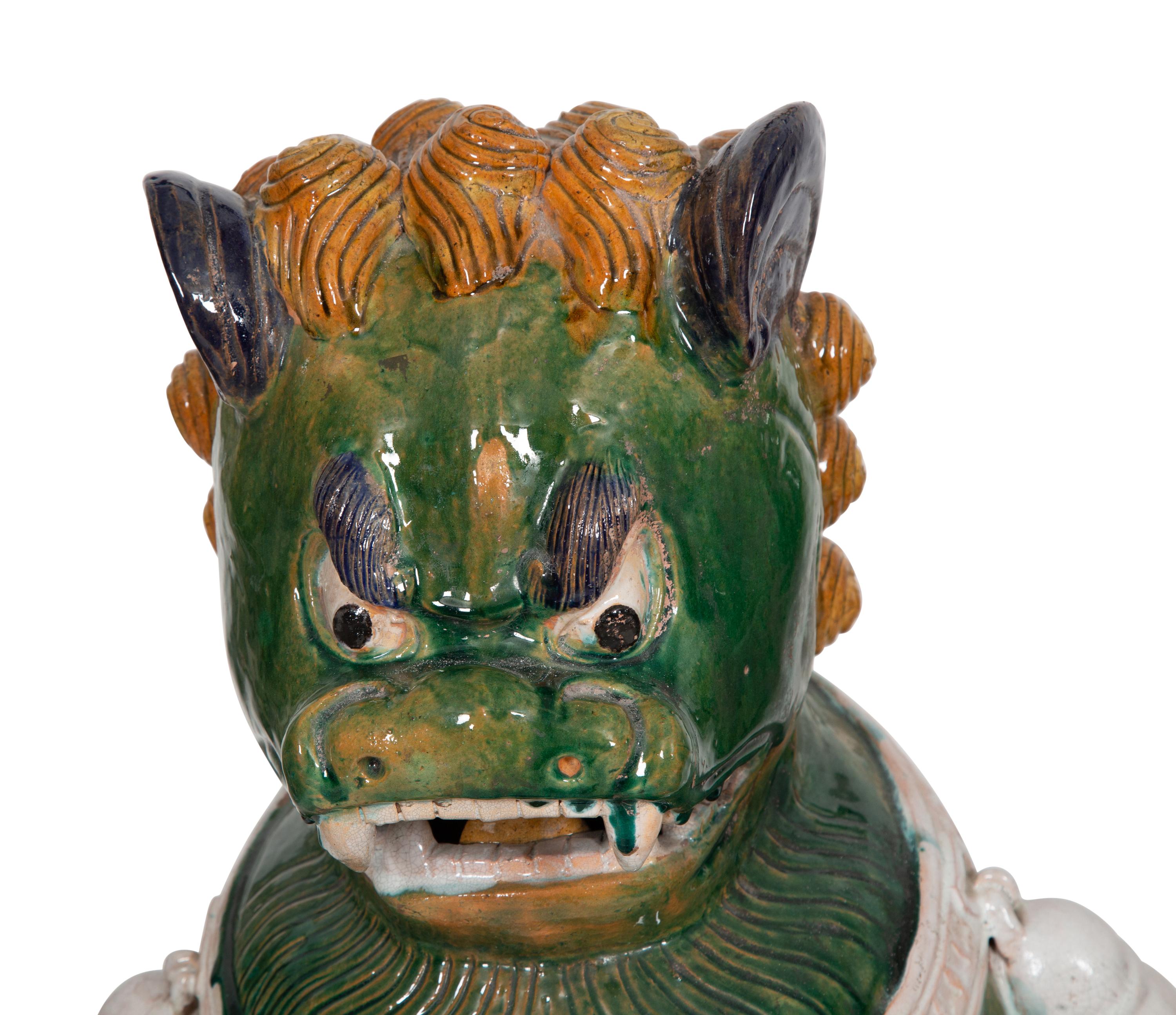 A Pair of Chinese Sançai Glazed Ceramic Guardian Lions on Pedestal Bases